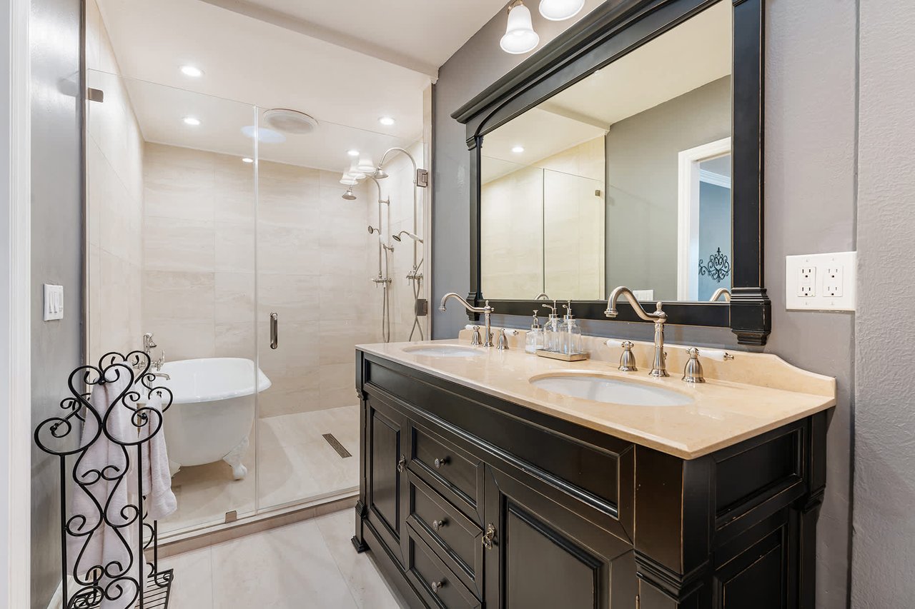 Spa inspired master bath with clawfoot tup and two shower systems