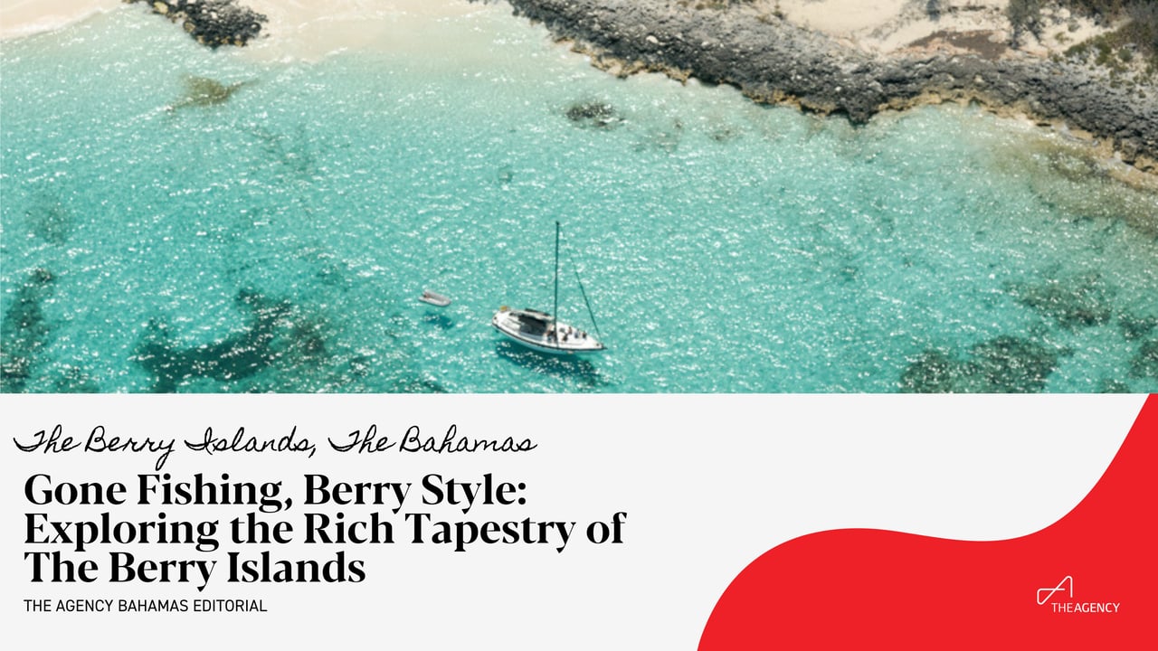  An aerial view shows a small sailboat anchored in shallow, clear turquoise waters near a rocky and sandy coastline.