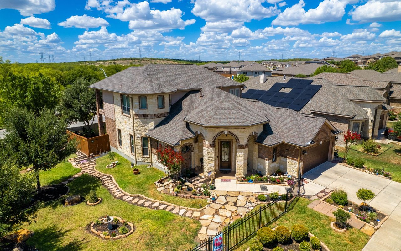 an aerial photo of a luxury stoned wall home in Bandera San Antonio