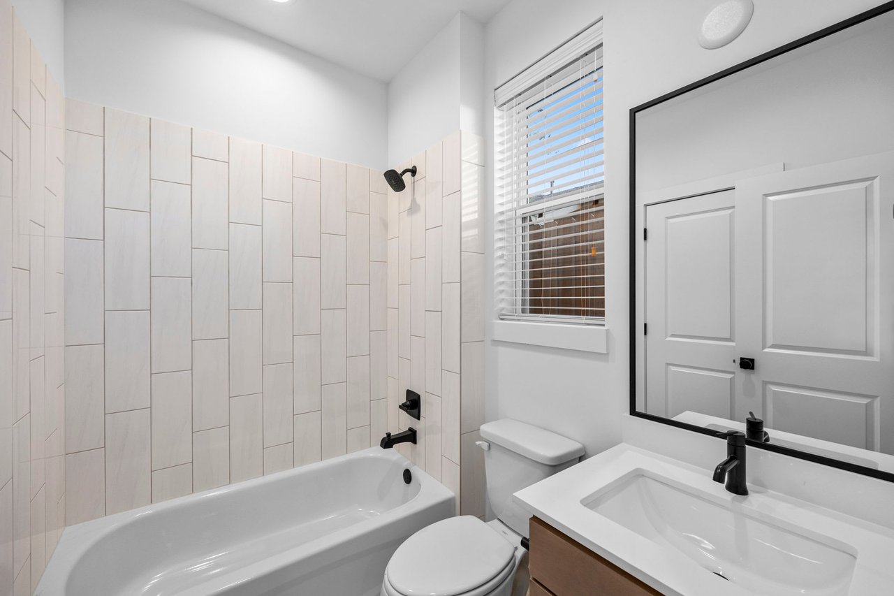 guest bathroom with a tiled shower