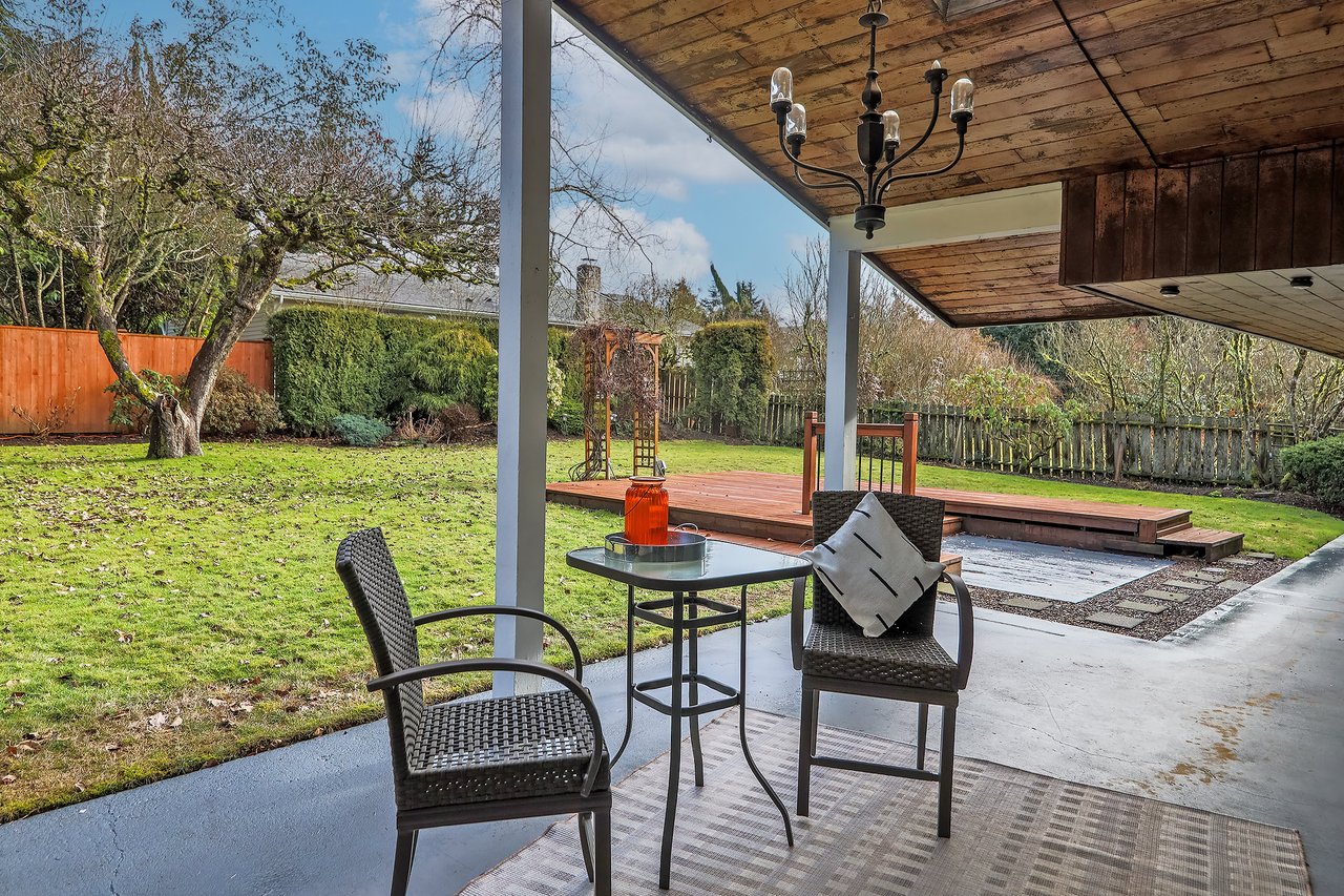 Relish in outdoor comfort on the covered patio, overlooking the expansive and private backyard—a perfect setting for leisure, entertainment, and relaxation.