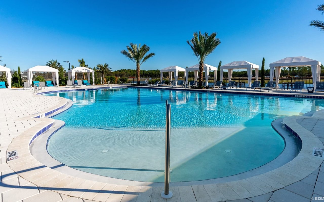 A large, rectangular swimming pool with a curved entry.