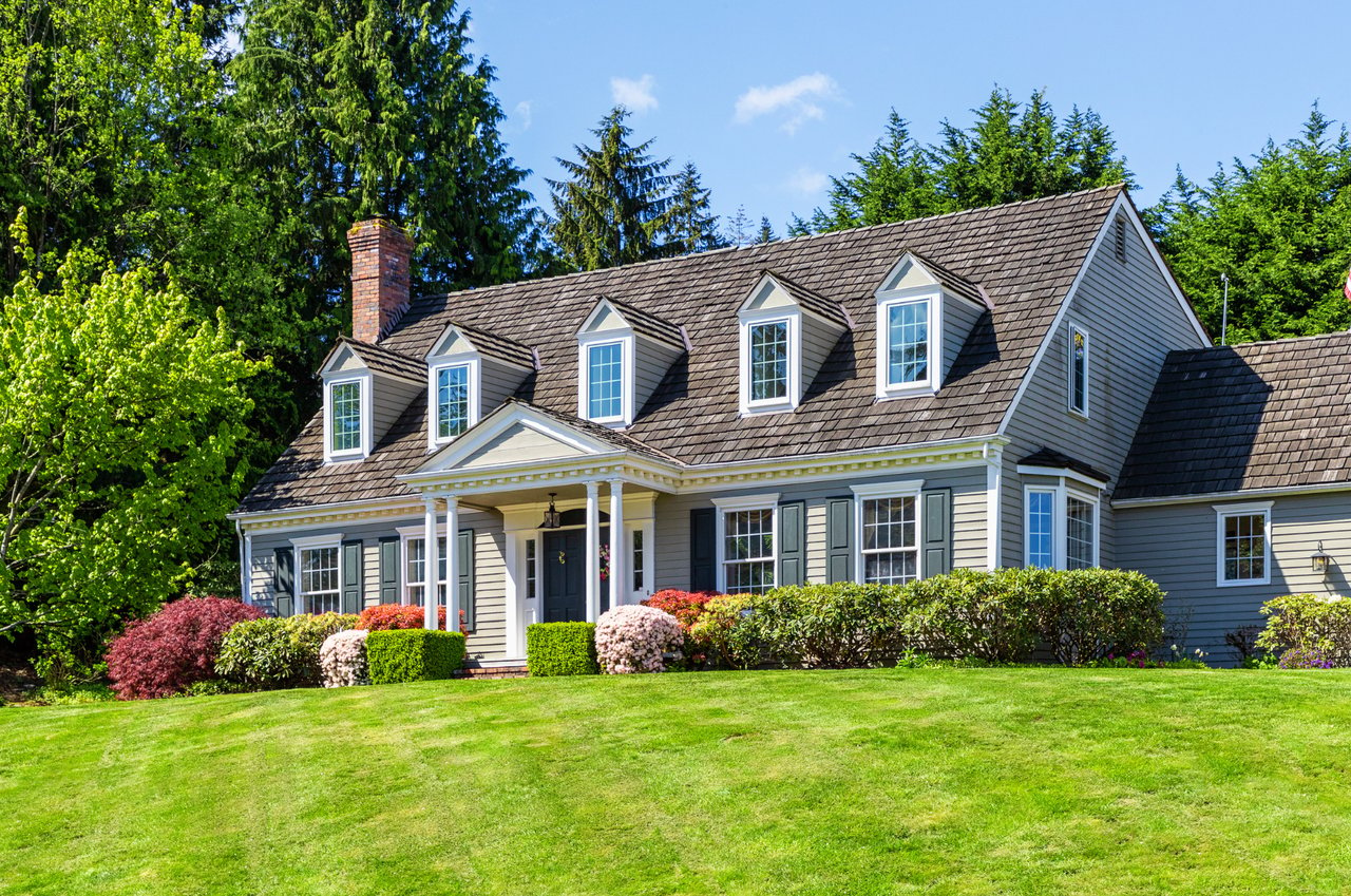 A large house with a lush green lawn in front of it.