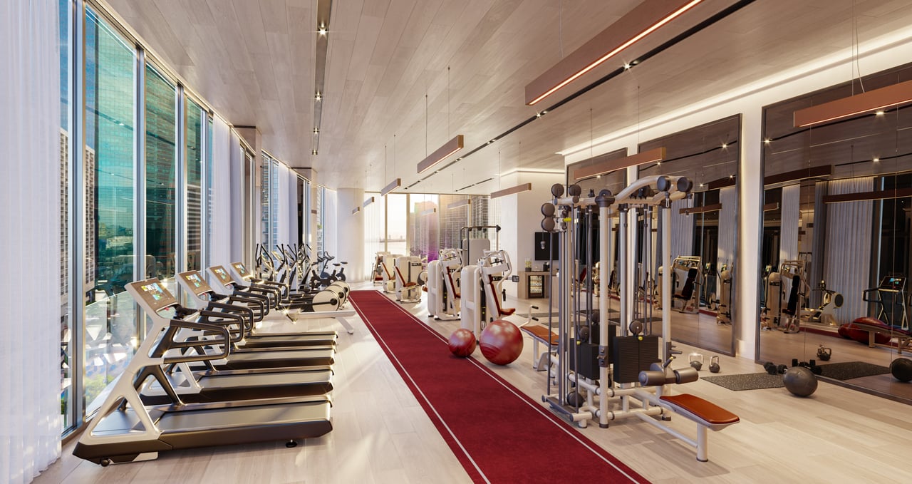 Baccarat fitness center with treadmills, mirrored walls, and a red exercise track.