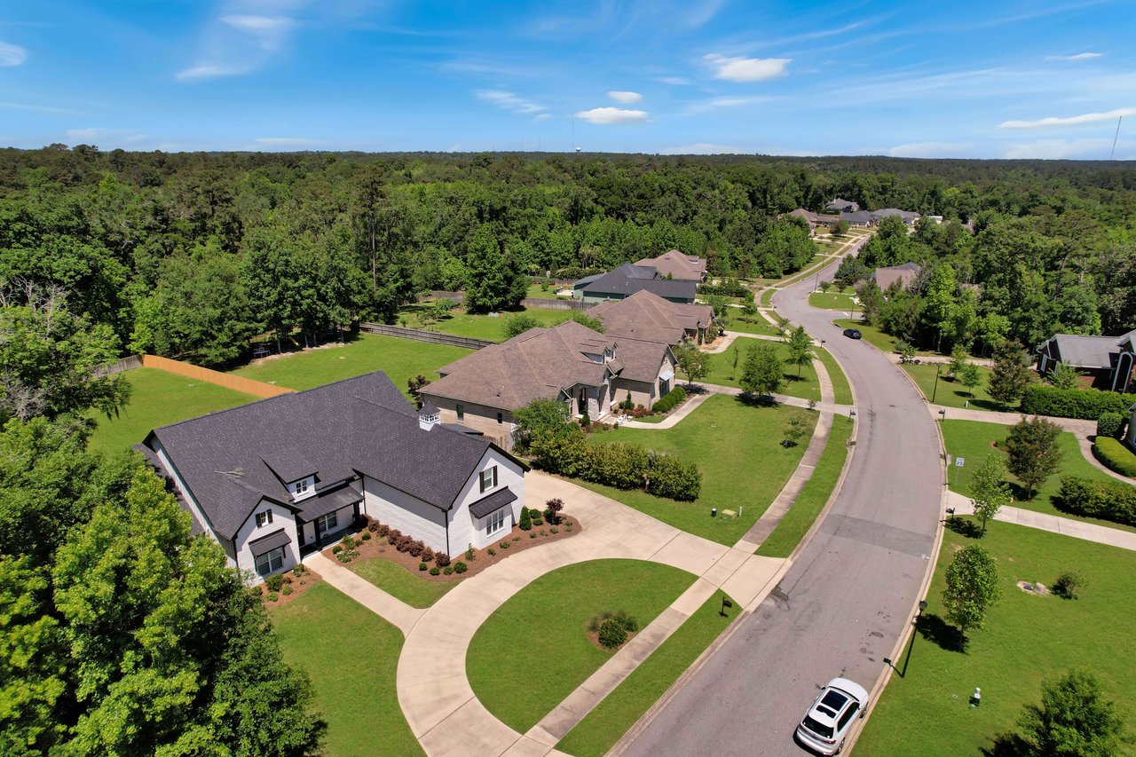 An aerial view of the Bull Run community, showing houses along a curved street and surrounding greenery.