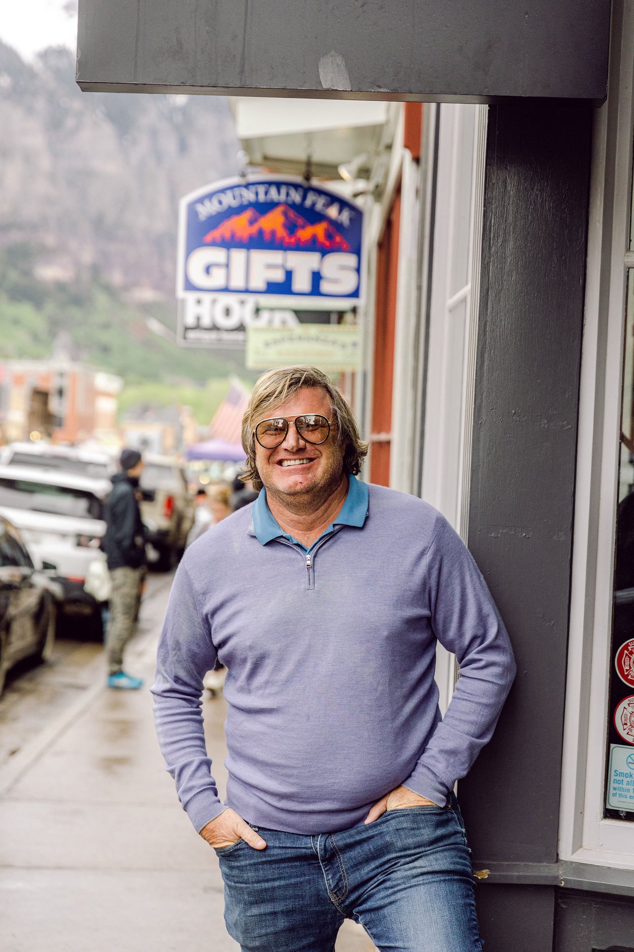 Ben Jackson in purple sweater standing on a street in Telluride, Colorado.