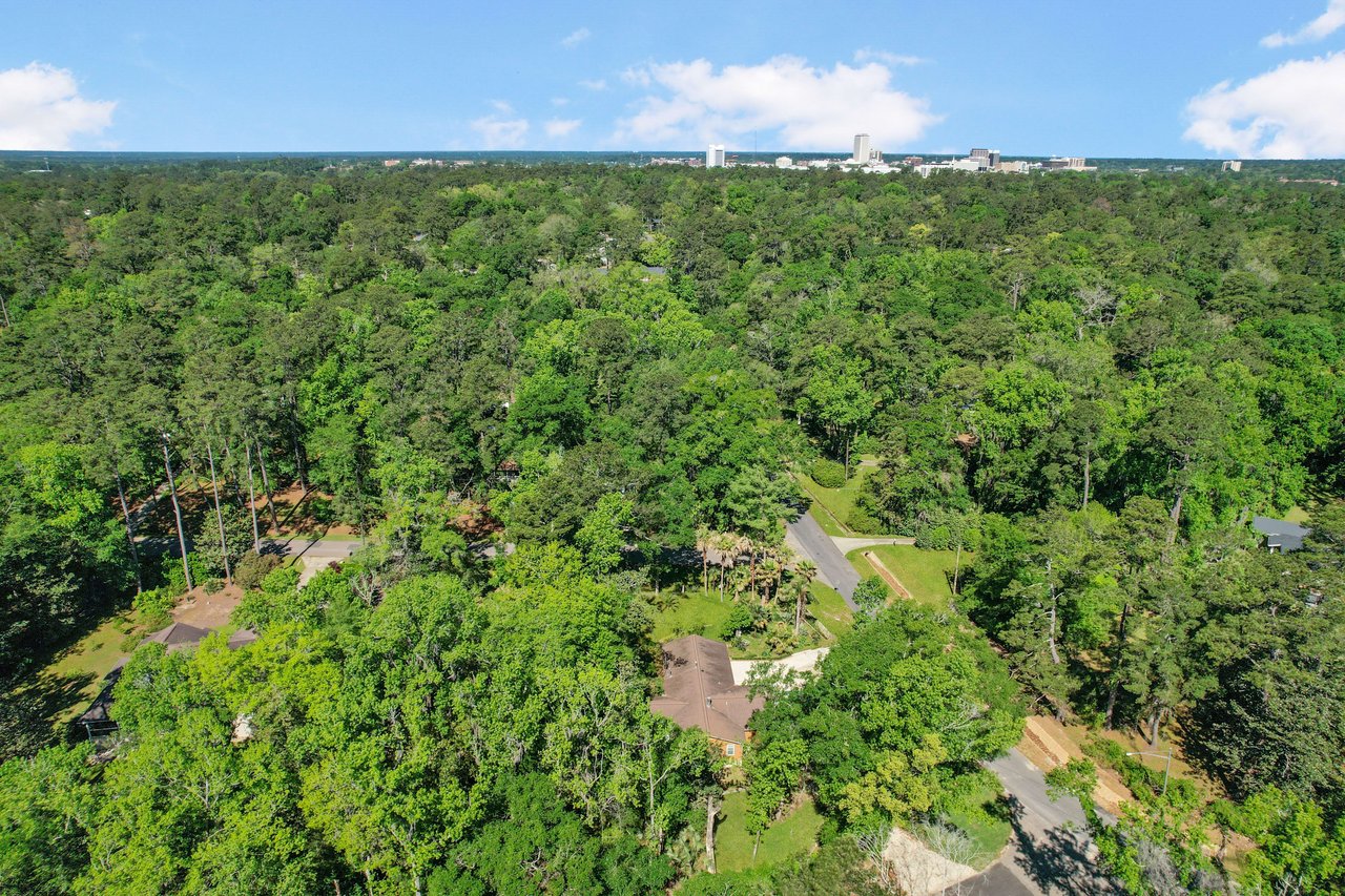 An aerial view of Indian Head neighborhood surrounded by dense tree cover, indicating a heavily forested area.