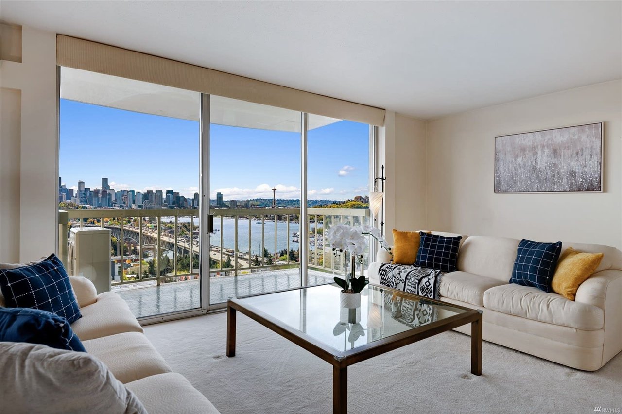 Elegant condo living area with chic decor and stunning city skyline views.