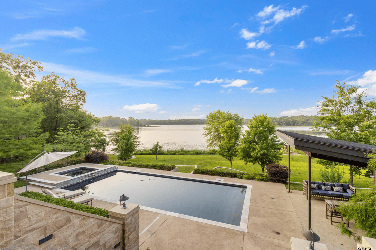 Pic of Contemporary pool and huge backyard with waterfront access to lake