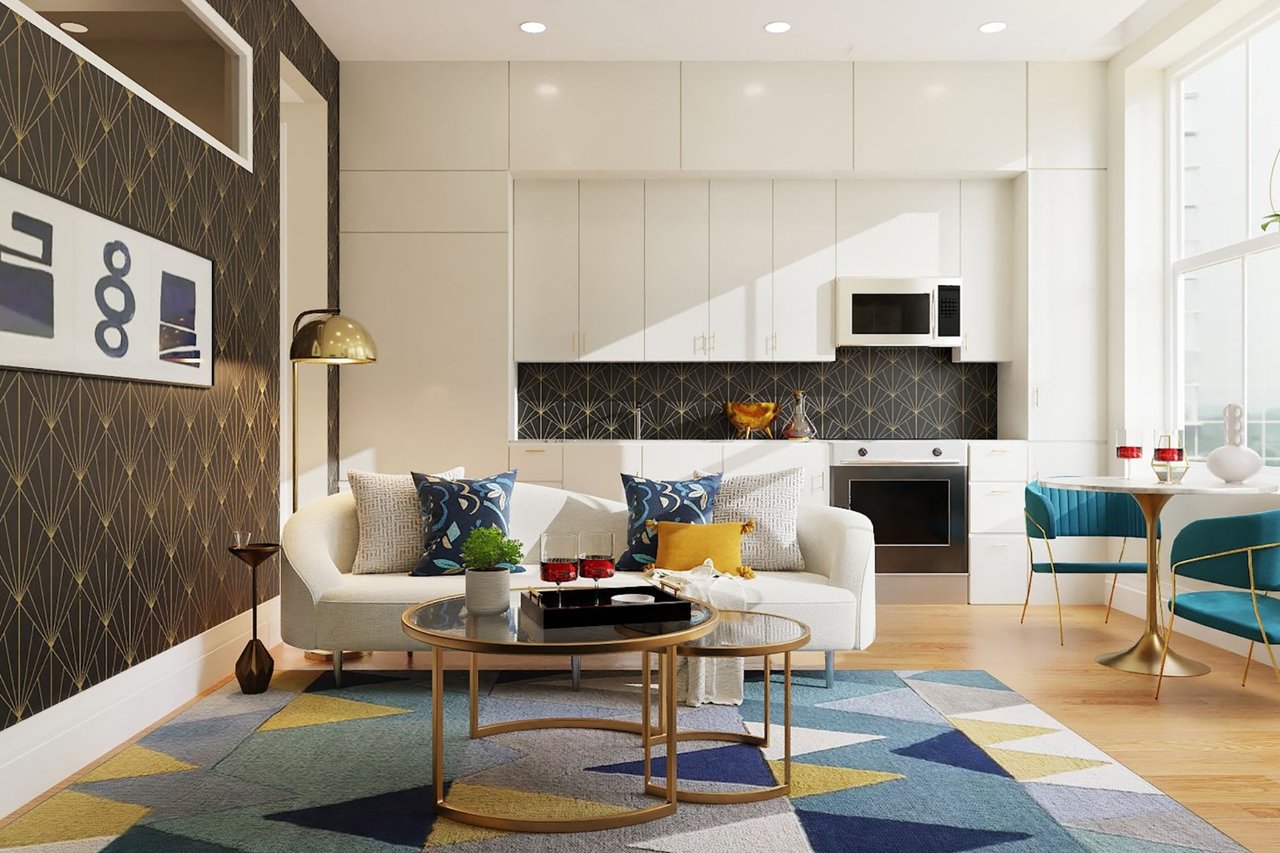 Stylish living room and kitchen with geometric wallpaper, white cabinets, patterned rug, and cozy sofa with colorful pillows.