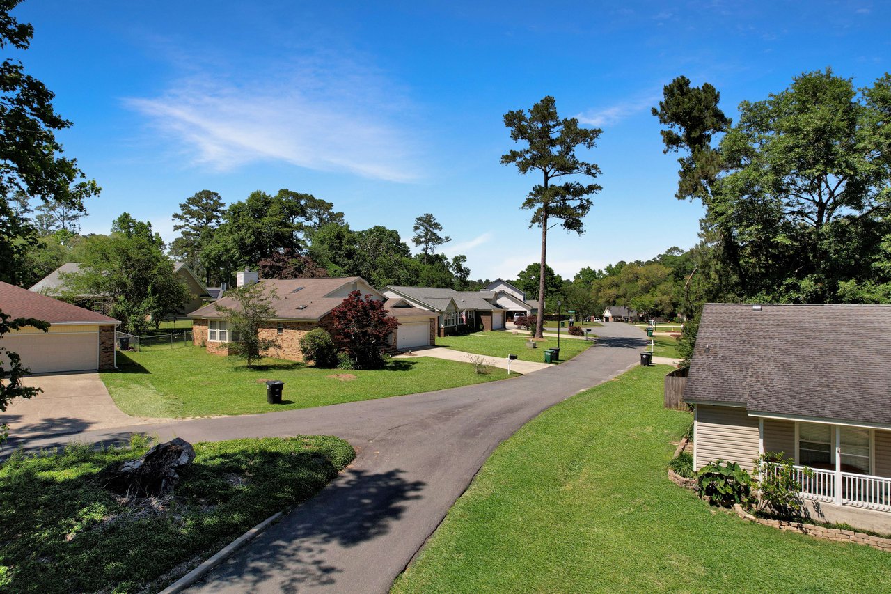 A ground-level view of a street in the Centerville Trace community, showing houses and well-maintained lawns.