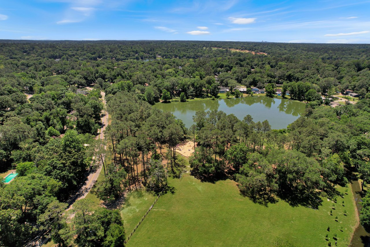 Another aerial view of Killearn Acres, focusing on a section with a lake and surrounding greenery.