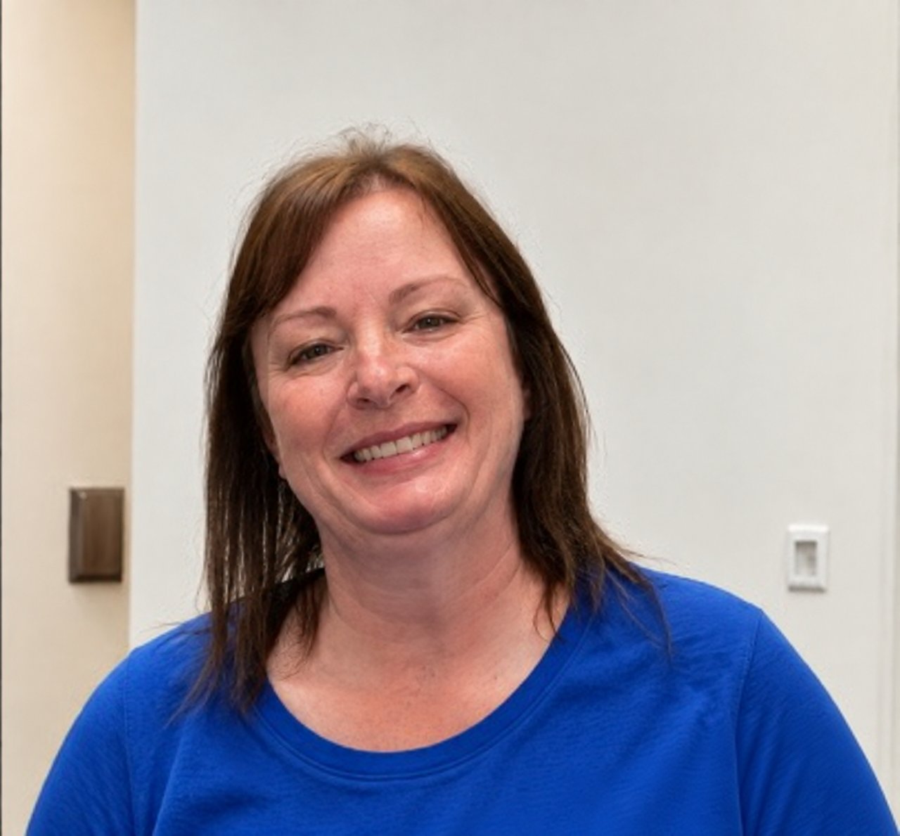 Sherry Payne smiling in a blue shirt.