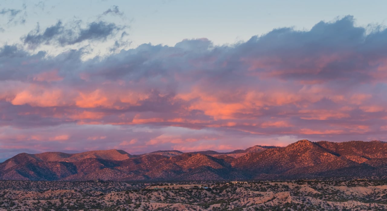 a beautiful view of mountain with beaming pink sunset