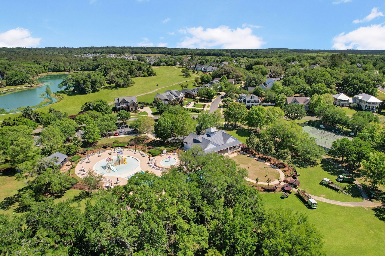 An aerial view of a residential area in Southwood with a large central area featuring what appears to be a community pool or recreational facility, surrounded by trees and houses.