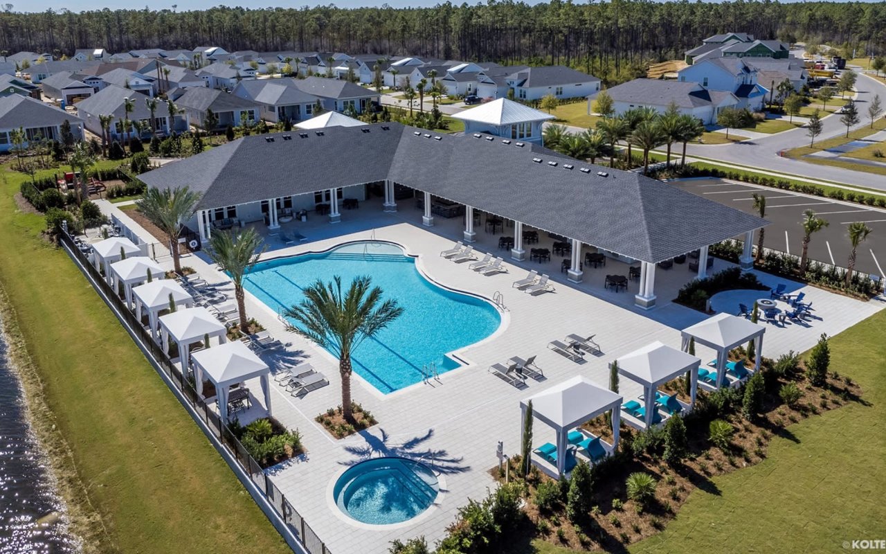 An aerial view of a community amenity center featuring a large swimming pool