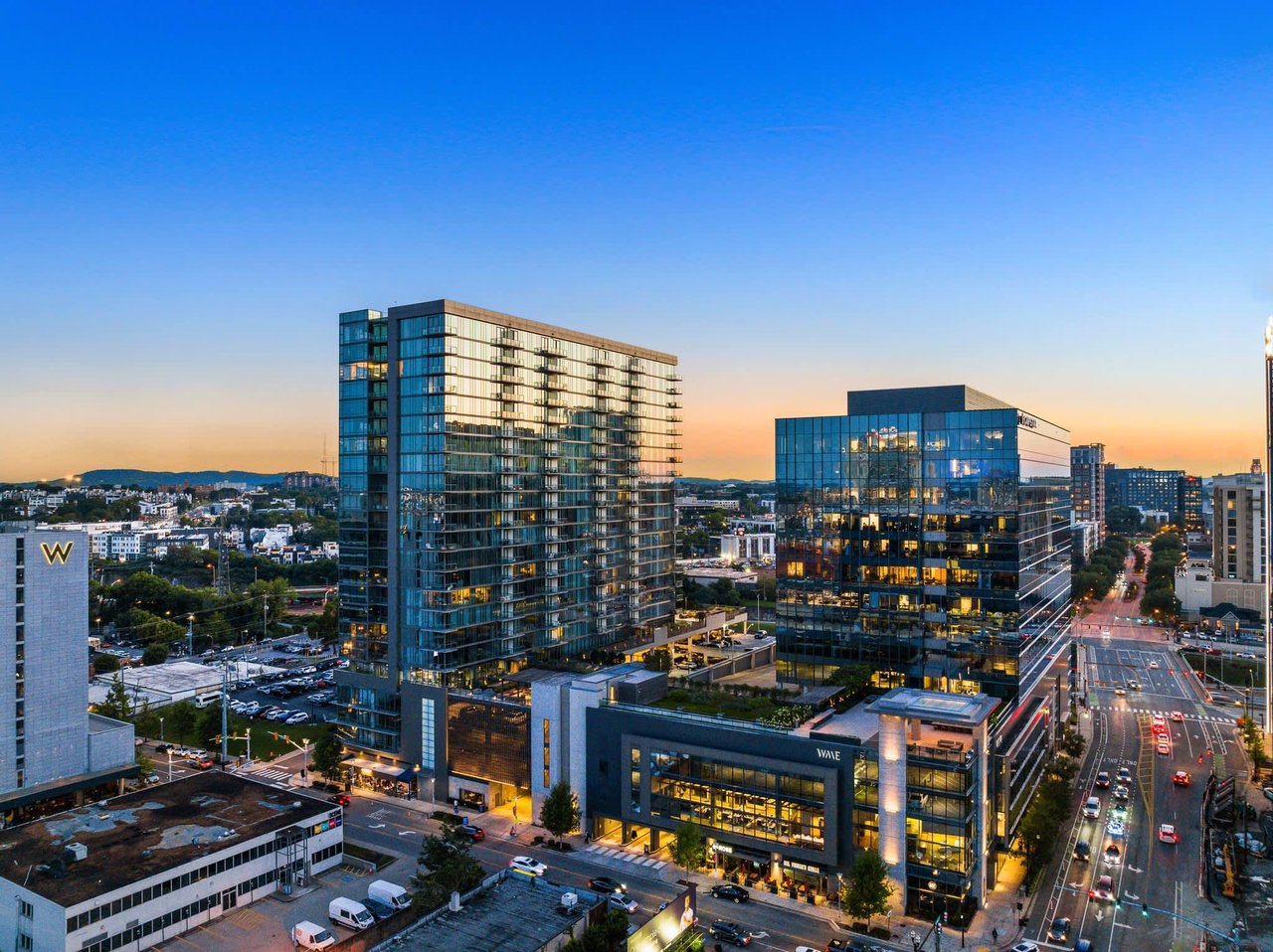 Exterior view of 1212 condo building in Nashville's Gulch neighborhood, showcasing modern glass facade and high-rise architecture.