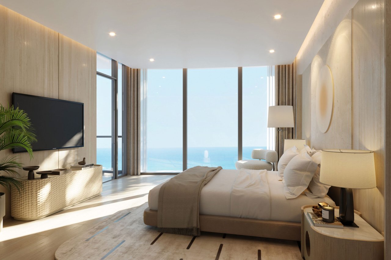 Luxury bedroom with floor-to-ceiling windows overlooking the ocean