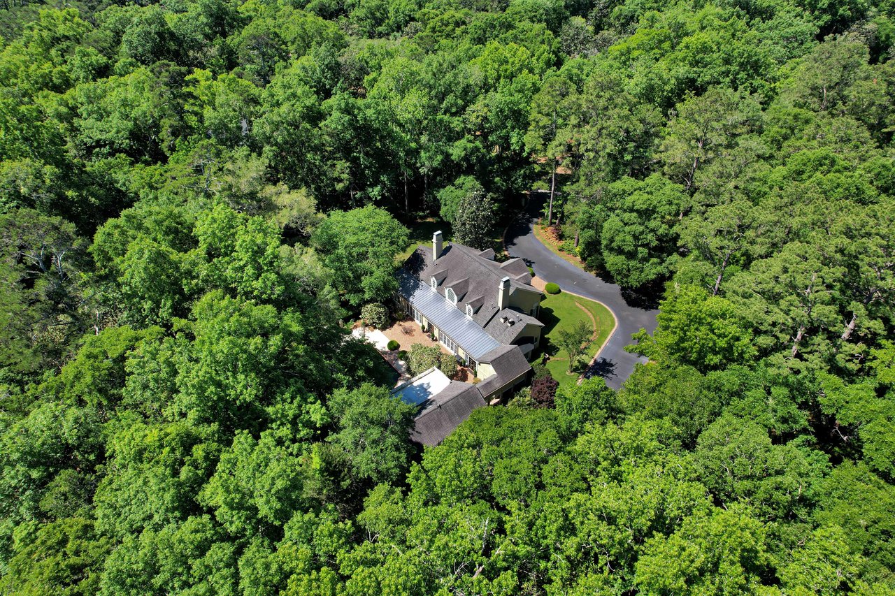 An aerial view of a large property within the Bobbin Brook community, surrounded by dense trees.
