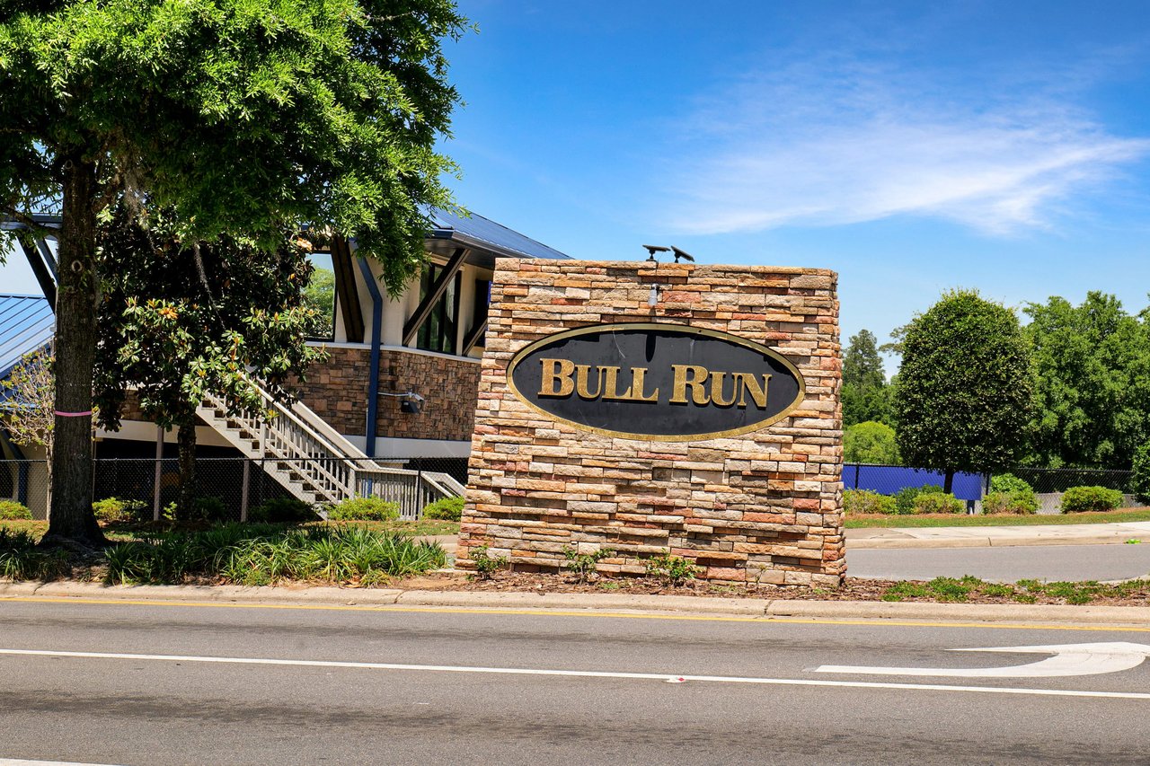 A ground-level view of the entrance sign for "Bull Run," marking the entrance to the community.