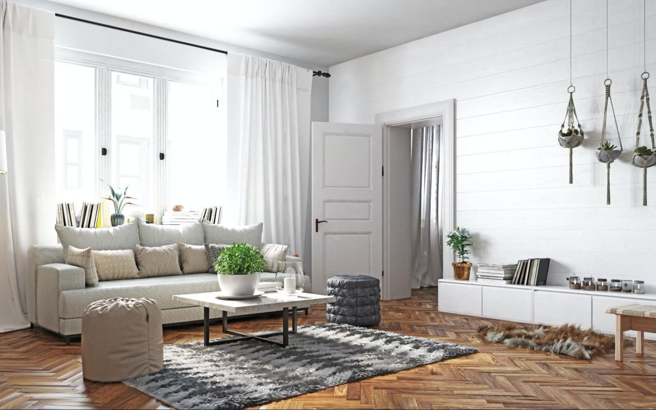 A modern living room with wood-like flooring, a white couch, a coffee table, hanging plants, and a large curtained window.