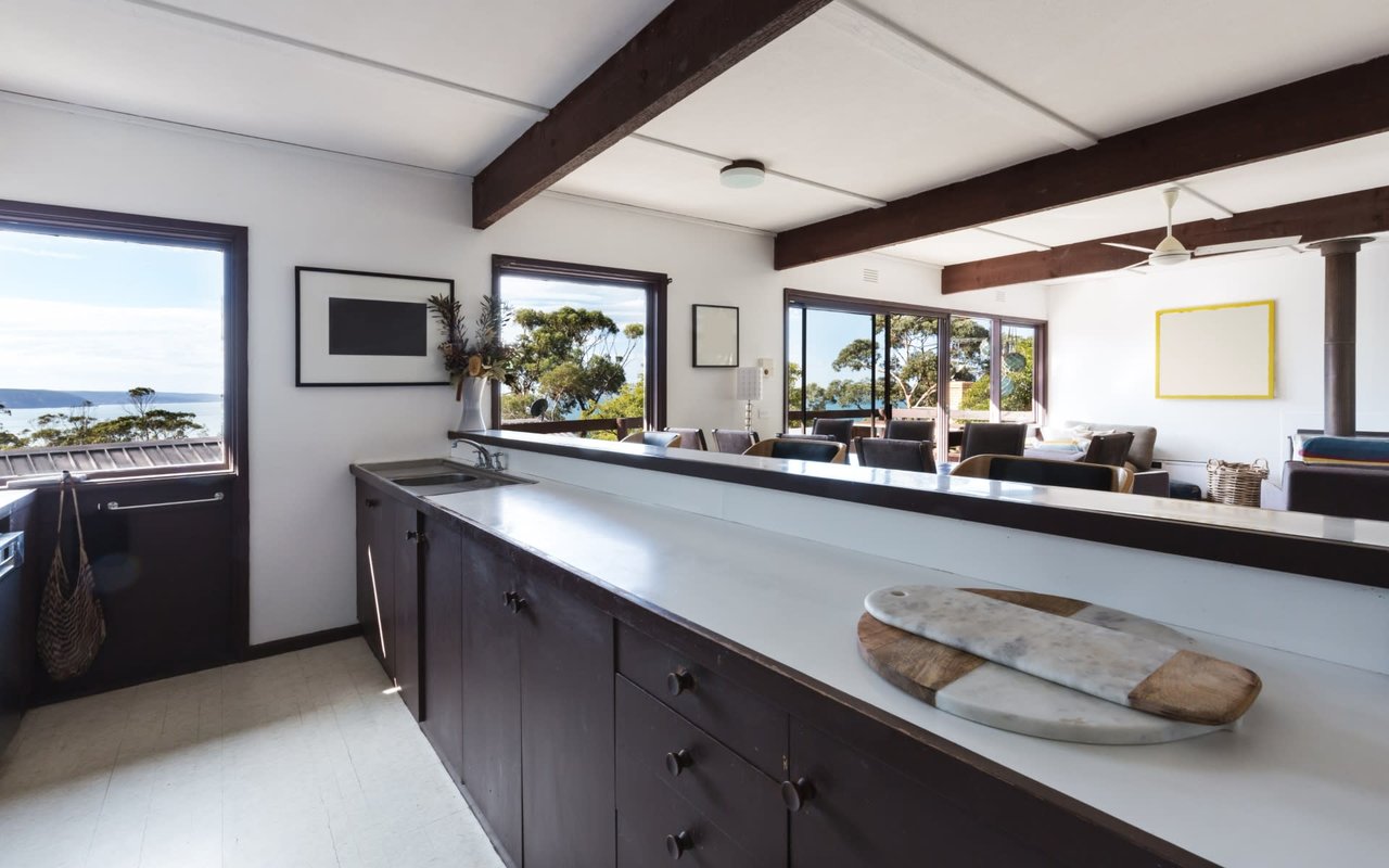 A contemporary kitchen and living area with stunning ocean views.