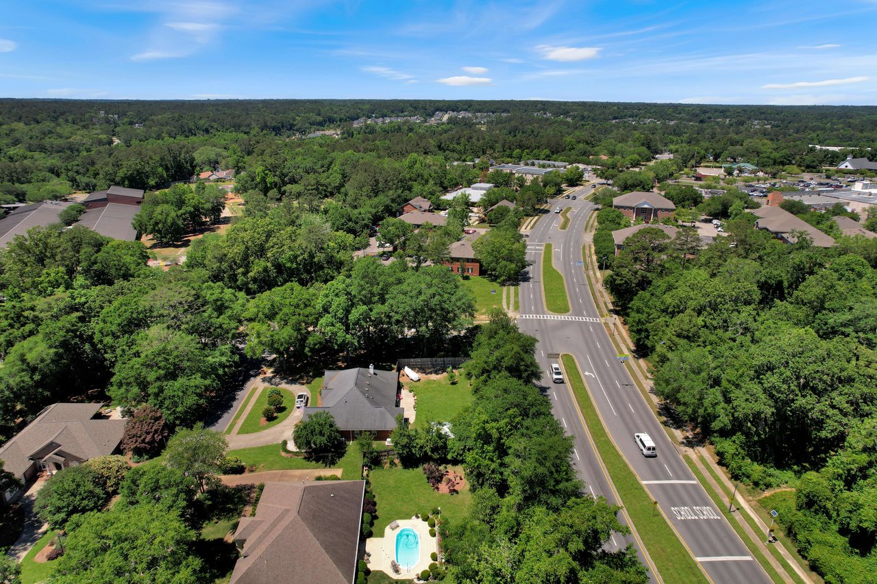 An aerial view of an area in Tredington Park  showing a broader view of the residential area, with tree-lined streets and houses.