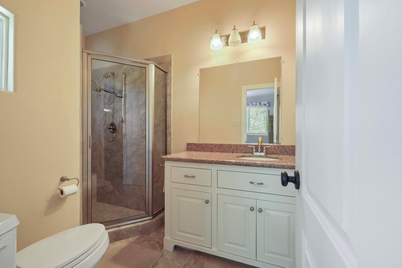 Ensuite bathroom with shower, single vanity, walkin closet.