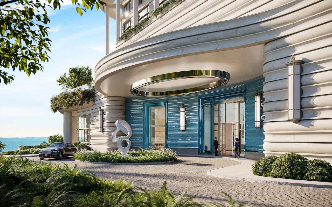 St. Regis Miami Residences entrance with a curved façade and blue entry wall beside the waterfront.