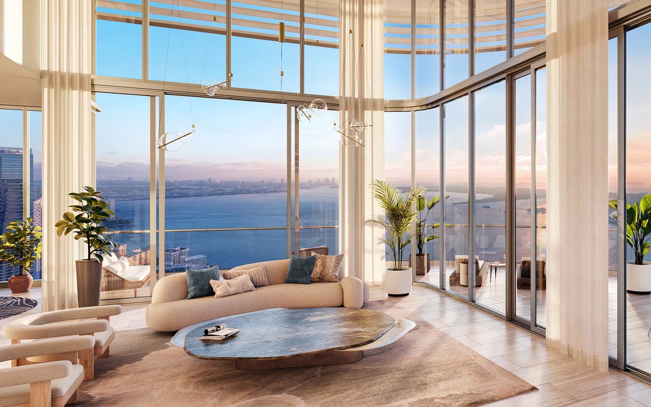 Luxury living room with floor-to-ceiling windows overlooking Biscayne Bay and the Miami skyline.