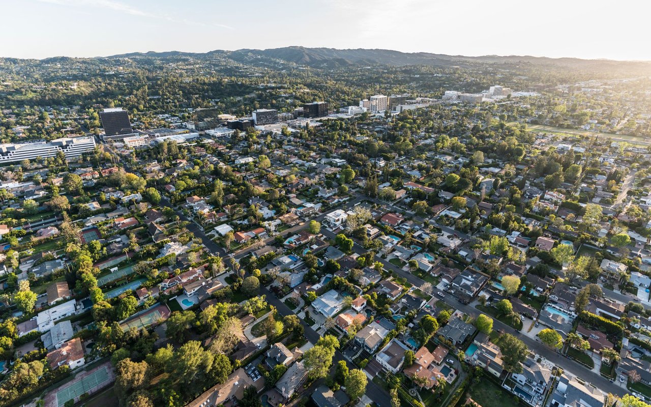 An aerial view of a residential neighborhood with houses and trees.