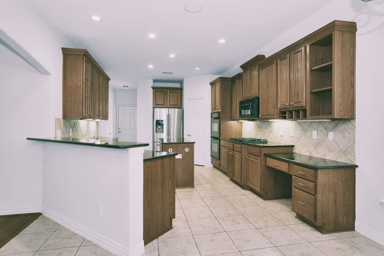 Kitchen view shows door to garage and this hallway leads to half bath, pass through to formal dining, and laundry room.