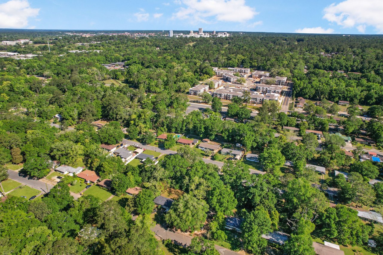 An aerial view of a recreational area within Apalachee Ridge Estates, featuring a pool and surrounding greenery.