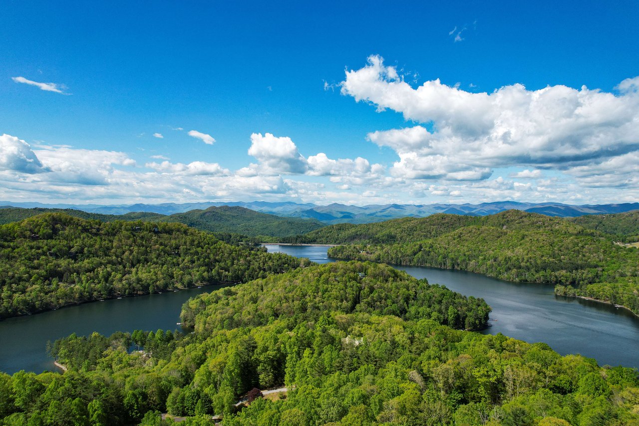 a lake curving around a forest in western north carolina lake glenville