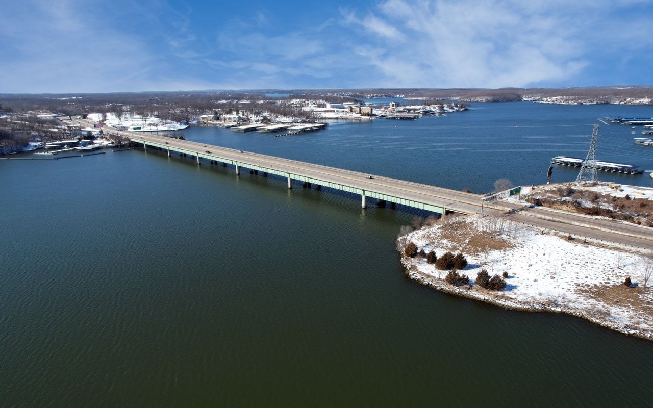 A long concrete bridge spanning a wide lake