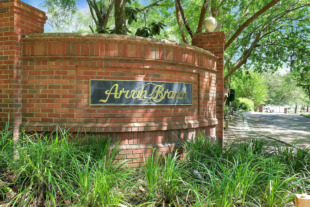 A ground-level view of the entrance sign for "Arvah Branch," indicating the name of the residential community.