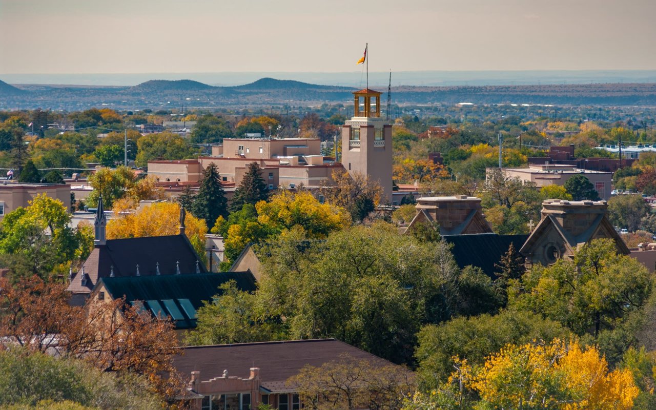 Aerial view of a city with trees and buildings in the fall