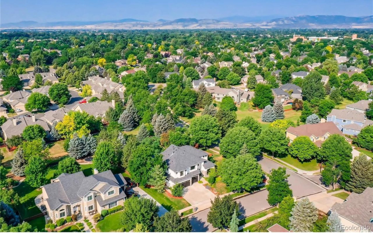 An aerial view of a residential neighborhood with houses of various shapes and sizes.