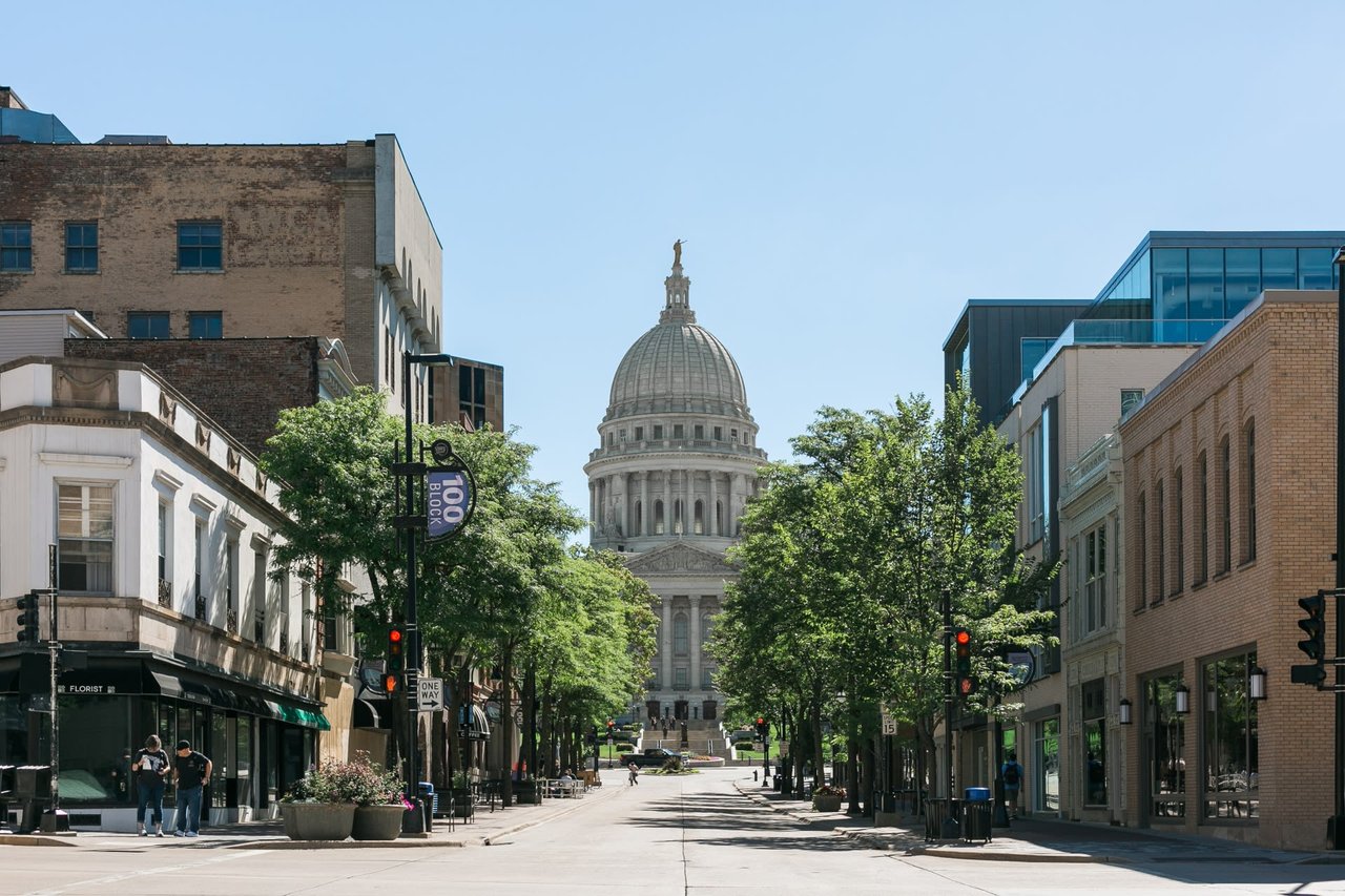 View down State Street in Madison, WI toward the State Capitol, showcasing the vibrant downtown area featured in Insiders Realty’s 2025 community guide.