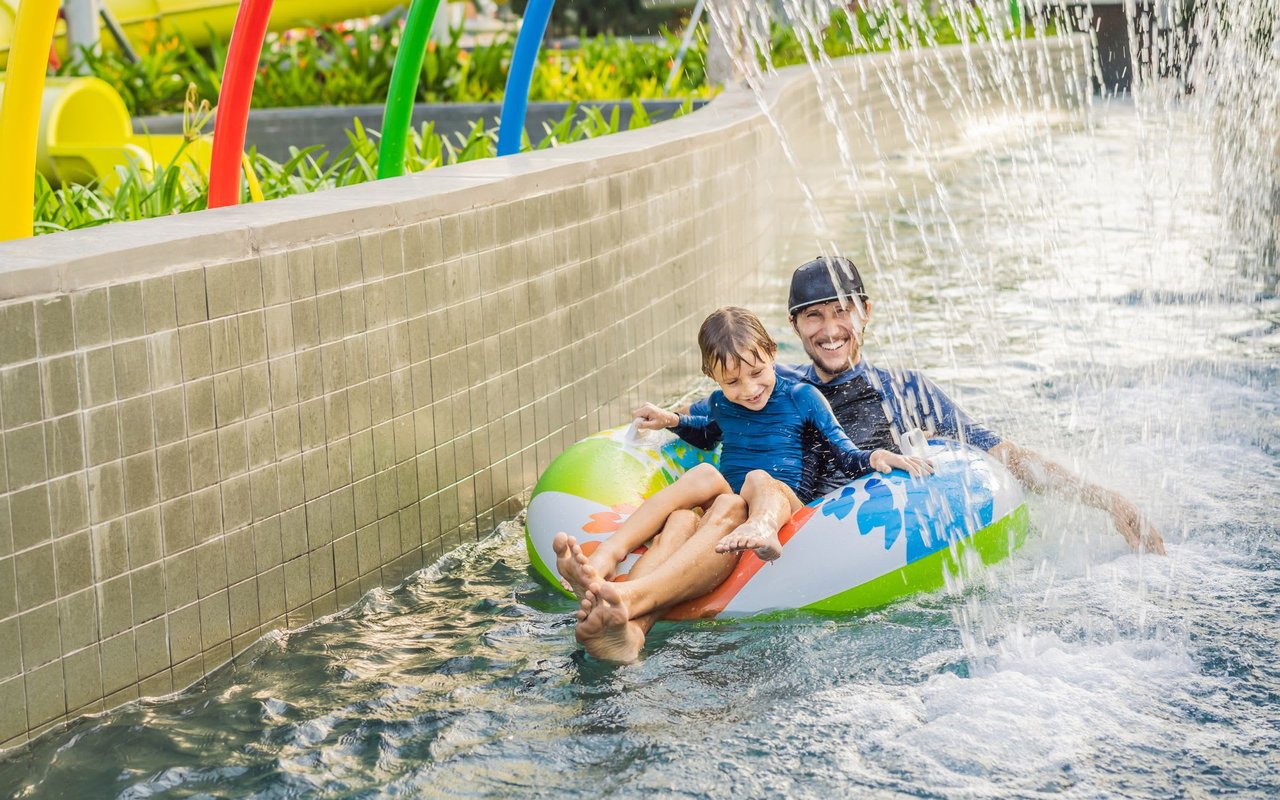 Father and Son on Swim Ring at a Water Park