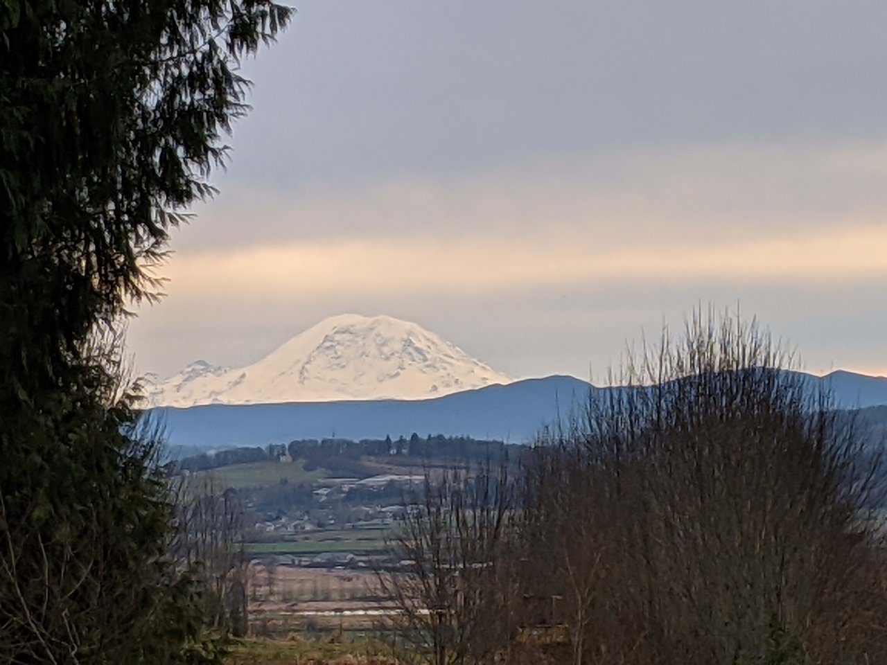 Beyond the home, you'll be treated to a breathtaking view of Mount Rainier, offering a picturesque backdrop that adds to the charm and allure of this remarkable property."