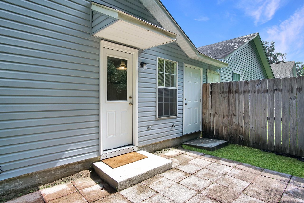 Photo of the back patio featuring Pavers, a fenced yard, and access to the outdoor utility storage closet  at 2709 Oak Park Court, Tallahassee, Florida 32308