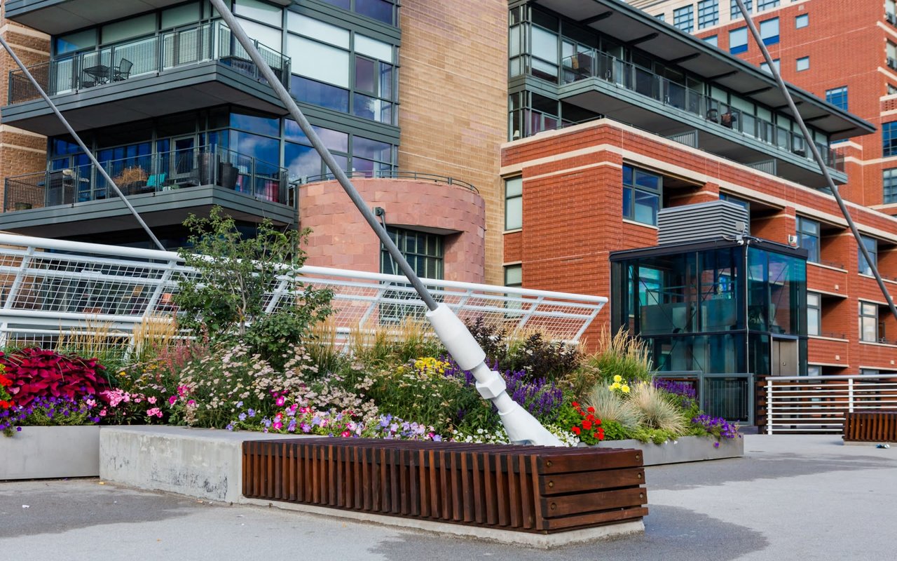 Highlands Ranch brick residential building with flower baskets.