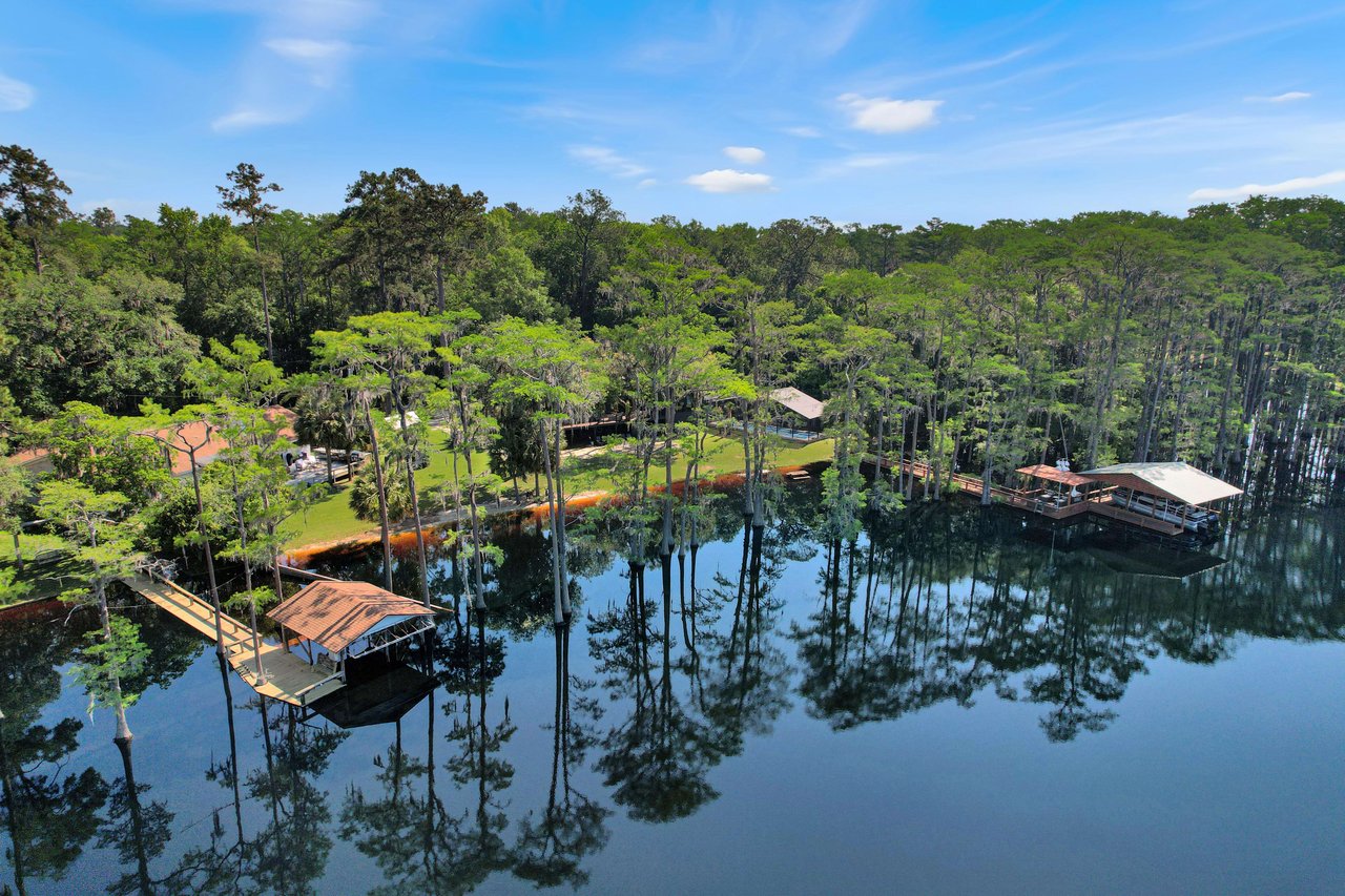 An aerial view of Lake Bradford Area showing more of the shoreline with houses and docks extending into the water.