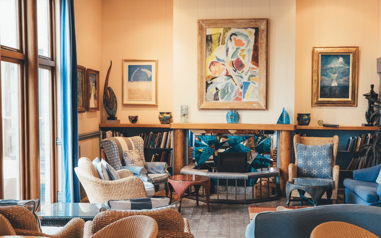  A vibrant and eclectically decorated living room features a central fireplace with an ornate