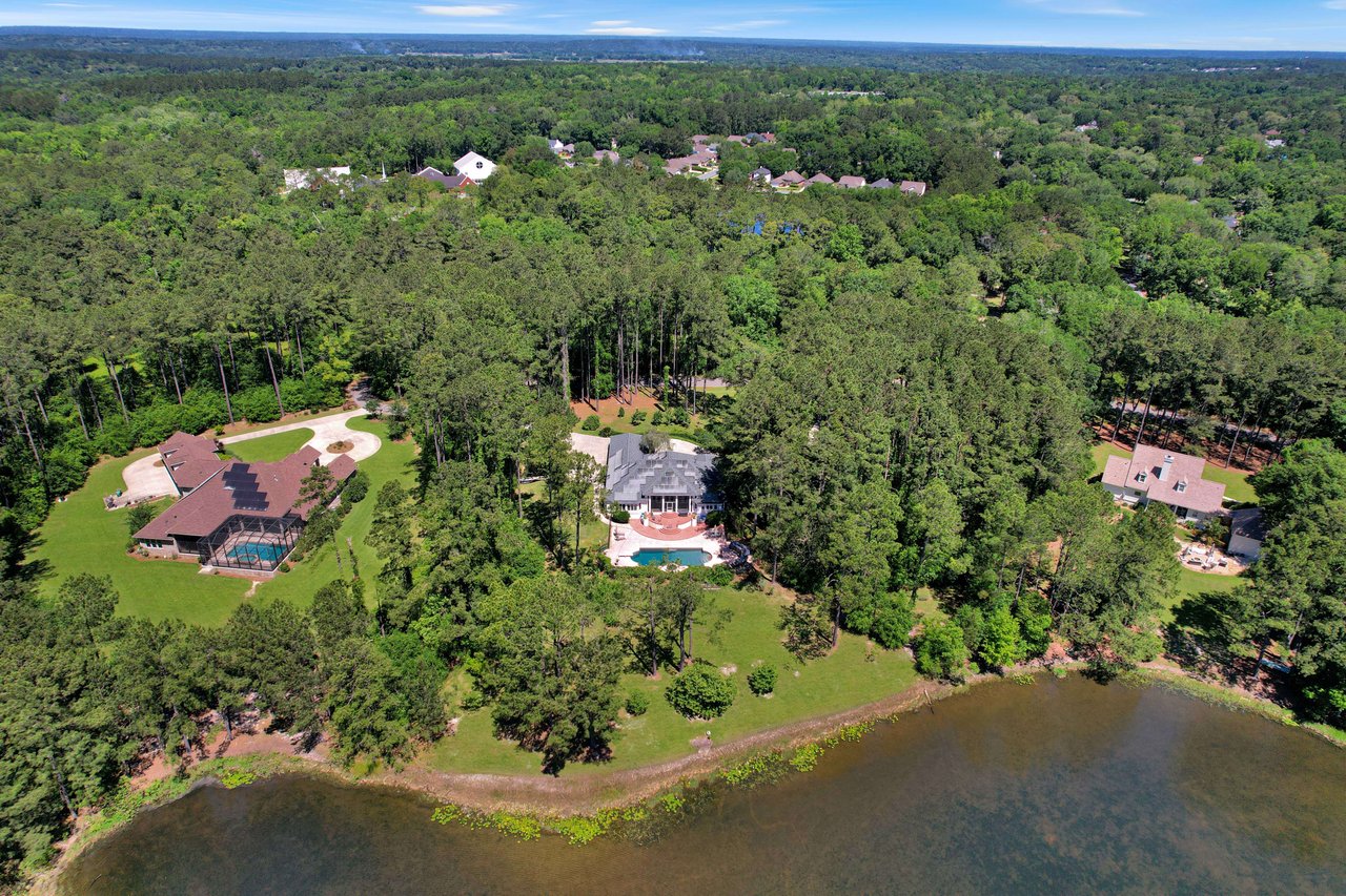 An aerial view of Rosehill residential area with houses, greenery, and a body of water.