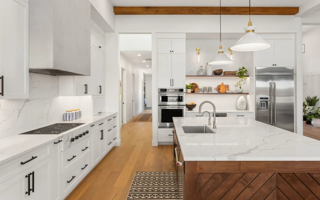 Sleek and modern kitchen with white cabinets and a large island, located in a Westlake Village, California home. 