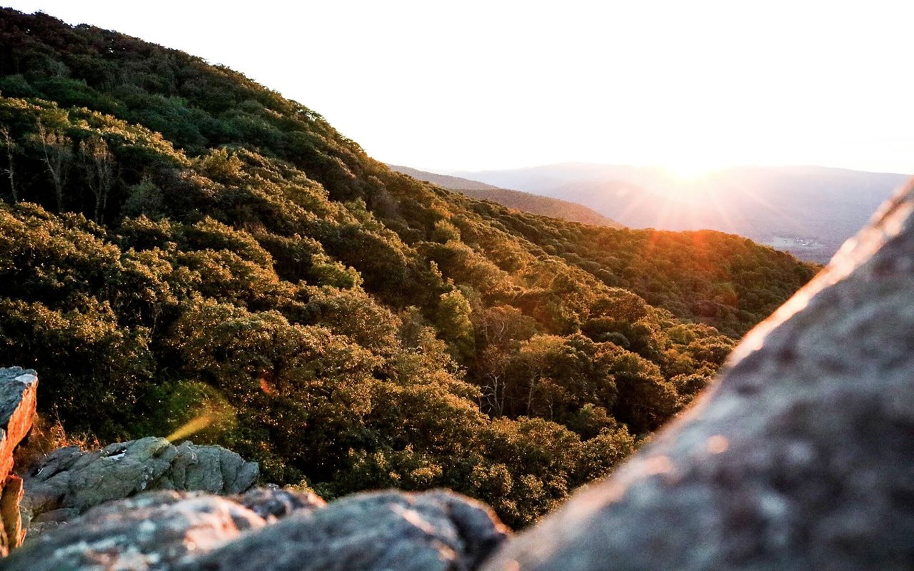 sun peaking over a mountain in Ottos North Carolina in Vignette realtys primary region