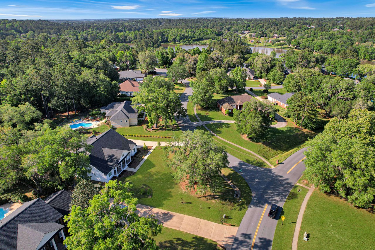  An aerial view of the Summerbrooke community, showing houses, streets, and greenery.