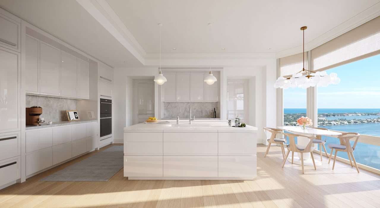 South Flagler House white luxury kitchen with breakfast table near floor to ceiling window overlooking intracoastal and ocean